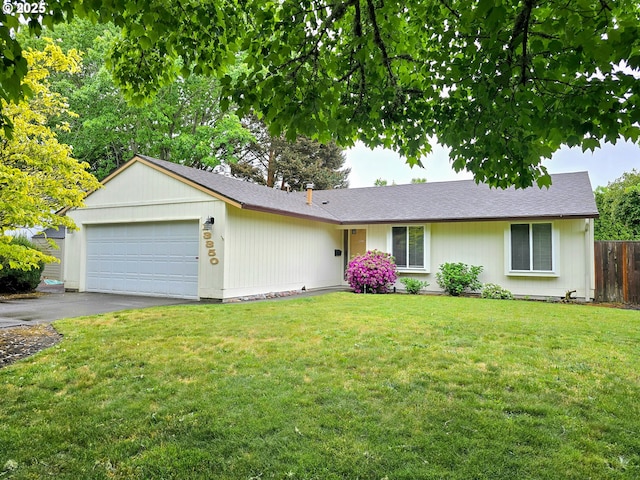 ranch-style house with an attached garage and driveway
