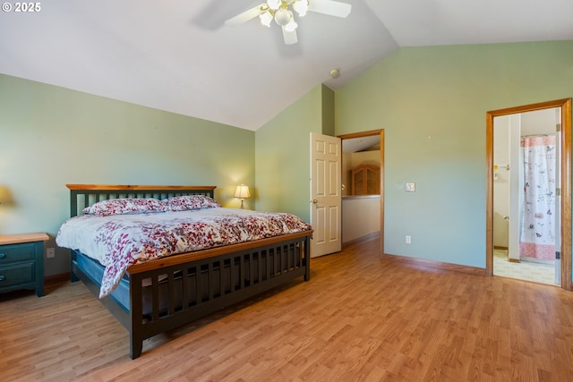 bedroom featuring vaulted ceiling, connected bathroom, ceiling fan, and light wood-type flooring