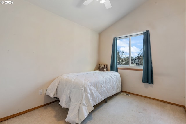 carpeted bedroom with vaulted ceiling and ceiling fan