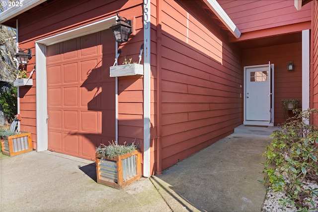 view of exterior entry with a garage