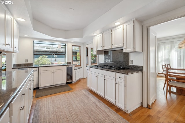 kitchen with a sink, a healthy amount of sunlight, wine cooler, and gas stovetop