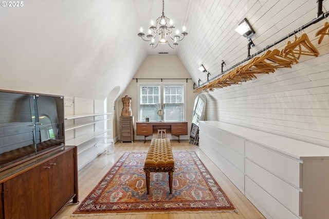 sitting room featuring an inviting chandelier, vaulted ceiling, light wood-type flooring, and visible vents