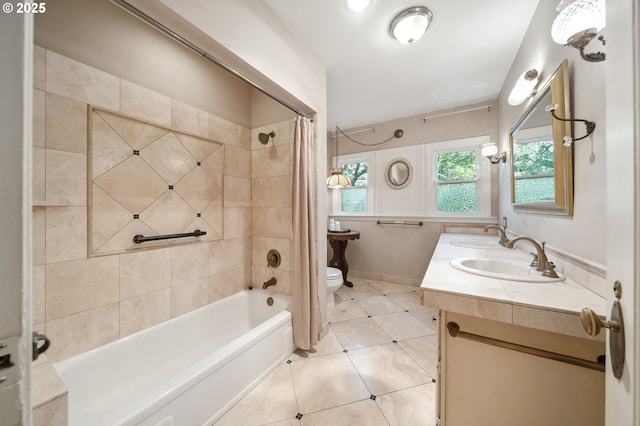 full bathroom with a sink, shower / tub combo, tile patterned floors, and toilet