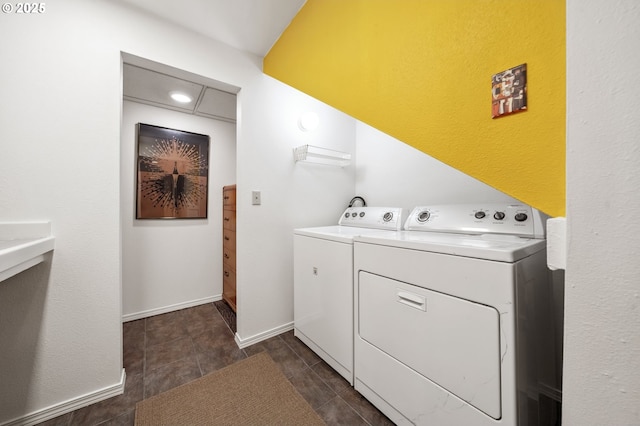 washroom with washing machine and clothes dryer and laundry area
