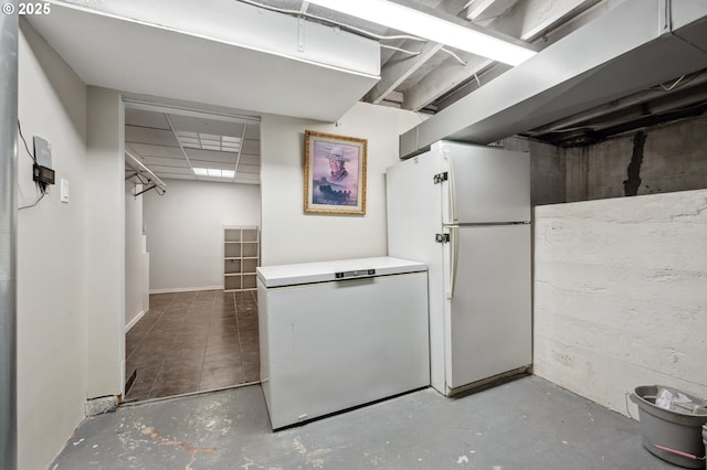 basement with freestanding refrigerator and fridge