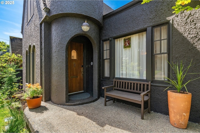 entrance to property featuring stucco siding