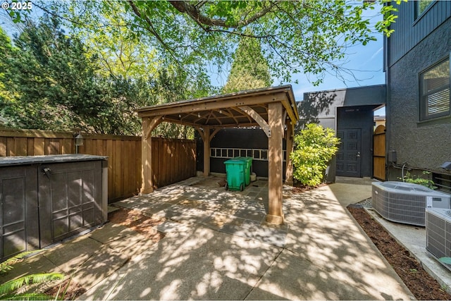 view of patio / terrace featuring fence, a gazebo, and central AC