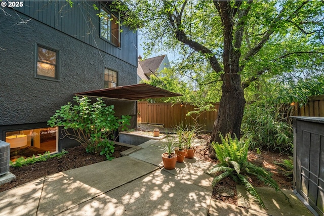 view of yard featuring fence and a patio