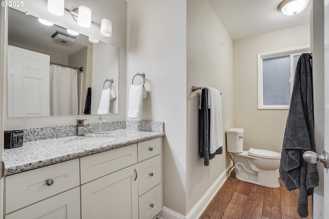 4718 SW Miles Ct, Portland, OR 97219 - full bathroom with wood finished floors, baseboards, toilet, and vanity
