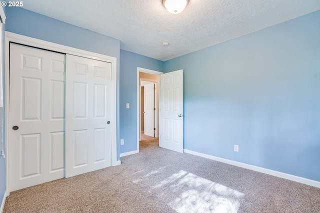 4718 SW Miles Ct, Portland, OR 97219 - unfurnished bedroom with carpet floors, baseboards, a closet, and a textured ceiling