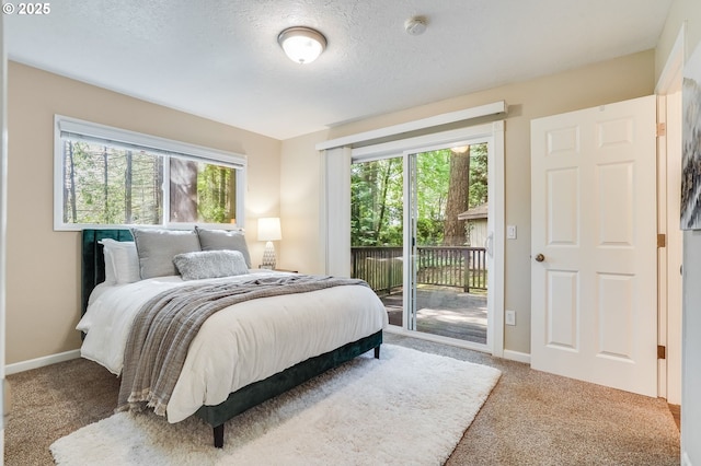 4718 SW Miles Ct, Portland, OR 97219 - bedroom with access to exterior, carpet floors, baseboards, and a textured ceiling