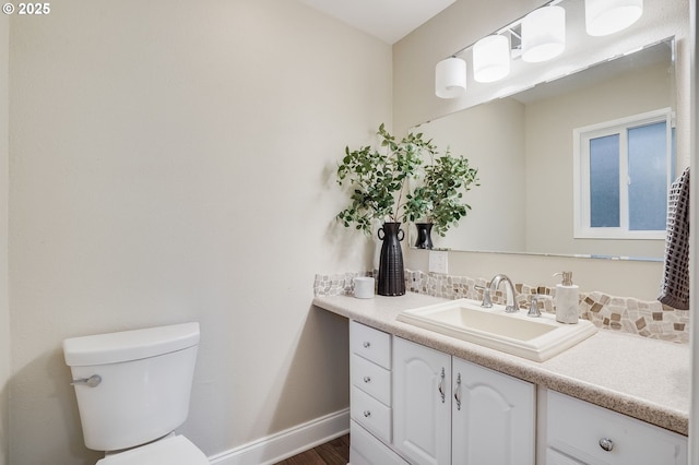 4718 SW Miles Ct, Portland, OR 97219 - bathroom featuring vanity, toilet, baseboards, and wood finished floors