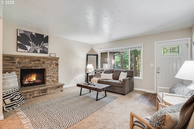 4718 SW Miles Ct, Portland, OR 97219 - carpeted living room featuring baseboards, a stone fireplace, and a textured ceiling