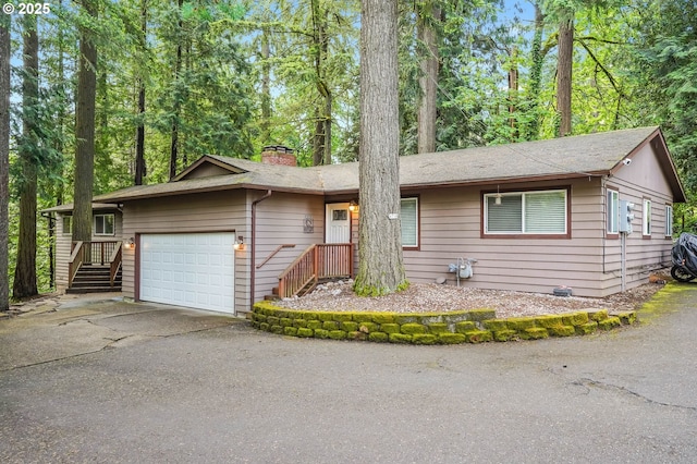 4718 SW Miles Ct, Portland, OR 97219 - single story home with a chimney, an attached garage, and asphalt driveway