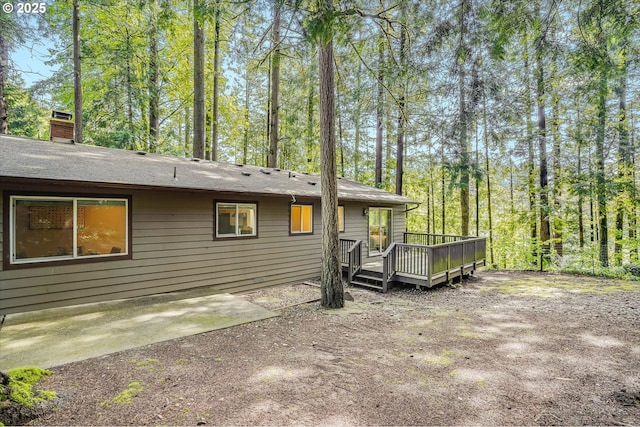 4718 SW Miles Ct, Portland, OR 97219 - back of property featuring a wooden deck and a chimney