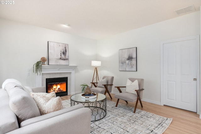 15530 SW Brighton Ct, Beaverton, OR 97007 - living room with light wood-style floors, a tile fireplace, and baseboards