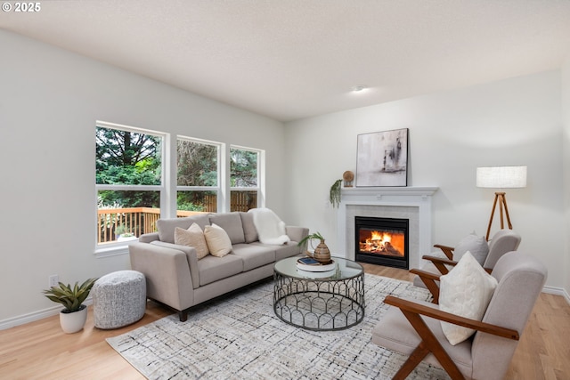 15530 SW Brighton Ct, Beaverton, OR 97007 - living room with wood finished floors, healthy amount of natural light, and baseboards