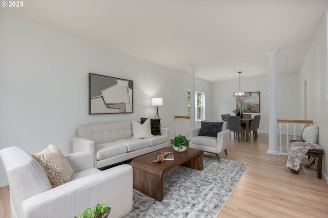 15530 SW Brighton Ct, Beaverton, OR 97007 - living area with light wood-style floors, baseboards, and decorative columns