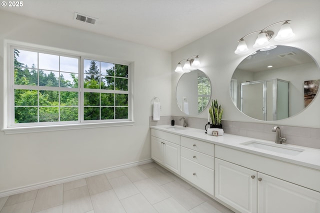 15530 SW Brighton Ct, Beaverton, OR 97007 - full bathroom featuring healthy amount of natural light, double vanity, baseboards, and an enclosed shower