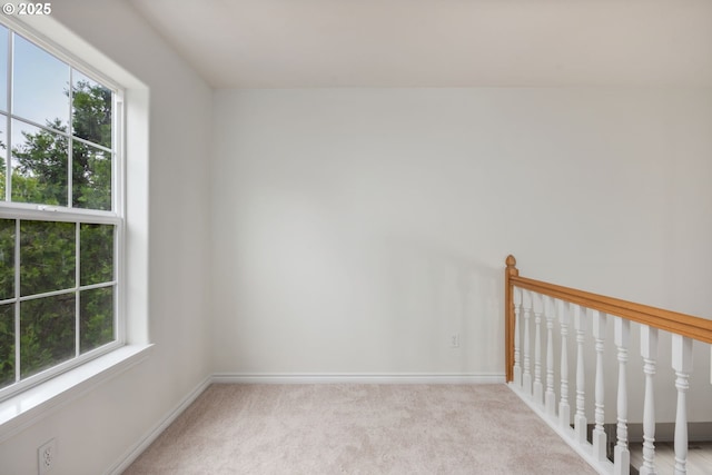 15530 SW Brighton Ct, Beaverton, OR 97007 - empty room featuring plenty of natural light, carpet flooring, and baseboards
