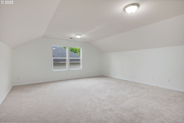 15530 SW Brighton Ct, Beaverton, OR 97007 - bonus room with light colored carpet, lofted ceiling, a textured ceiling, and baseboards