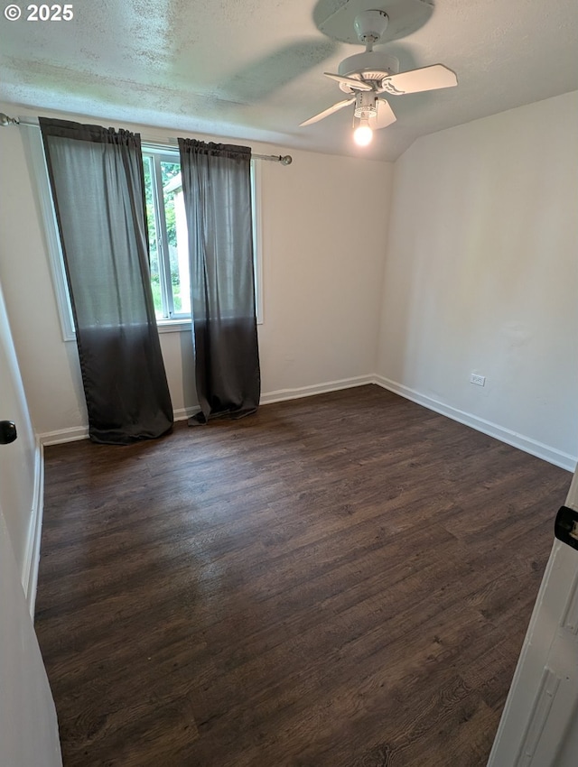 unfurnished room with dark wood-style floors, baseboards, ceiling fan, and a textured ceiling