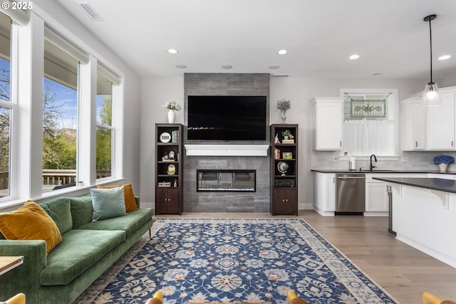 6621 NW Lolo Ter, Portland, OR 97229 - living room with a fireplace, wood finished floors, and recessed lighting