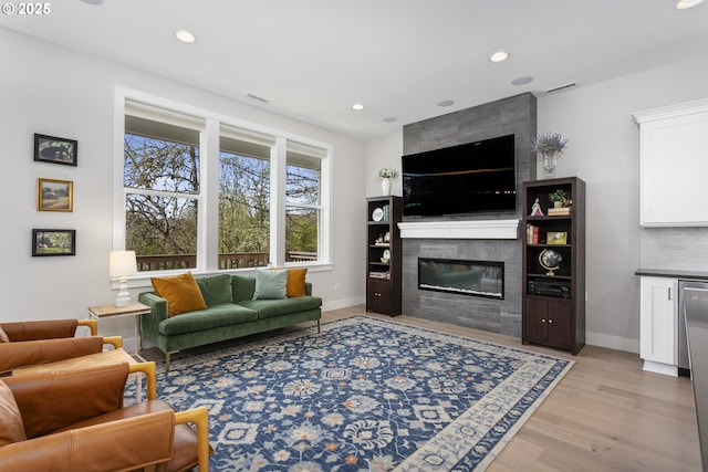 6621 NW Lolo Ter, Portland, OR 97229 - living area featuring a fireplace, light wood-style floors, and recessed lighting