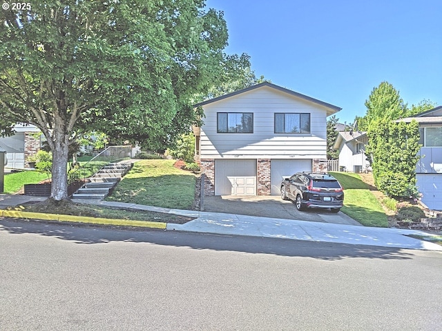 1367 NW Riverview Ave, Gresham, OR 97030 - view of front of house with stairway, driveway, an attached garage, and brick siding