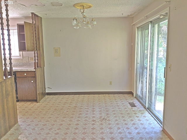 1367 NW Riverview Ave, Gresham, OR 97030 - unfurnished dining area with light floors, a chandelier, and a textured ceiling