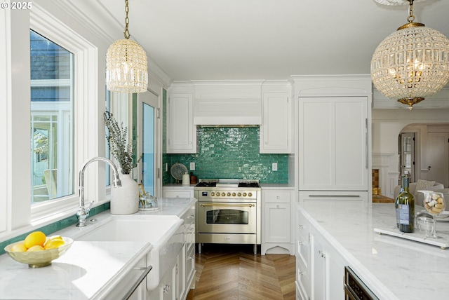 460 Bush St SE, Salem, OR 97302 - kitchen featuring a chandelier, high end range, white cabinetry, and a sink