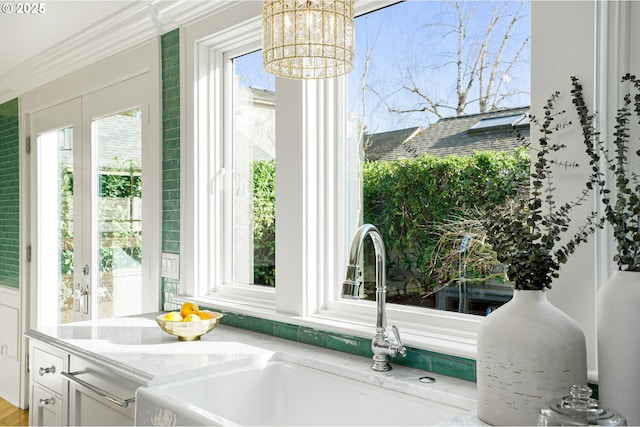 460 Bush St SE, Salem, OR 97302 - kitchen featuring a sink, a chandelier, white cabinets, and light stone countertops