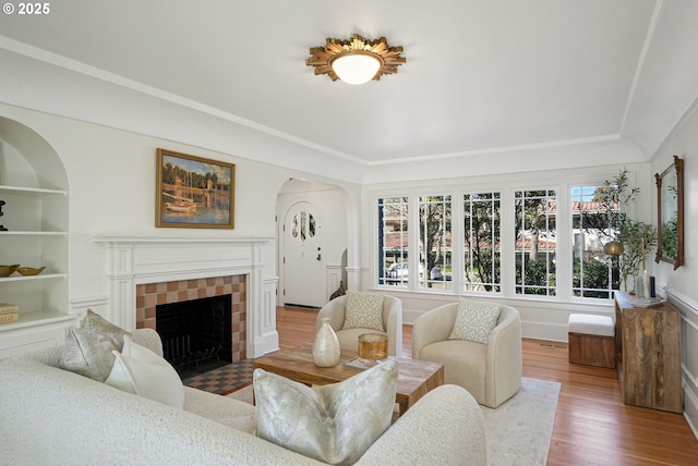 460 Bush St SE, Salem, OR 97302 - living area with wood finished floors, a tiled fireplace, built in features, and arched walkways