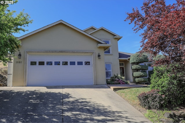 1680 NW Avery St, Roseburg, OR 97471 - traditional-style house featuring stucco siding, concrete driveway, and an attached garage