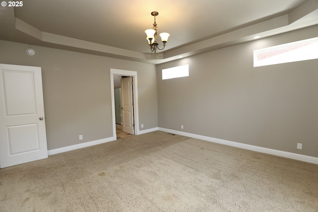 1680 NW Avery St, Roseburg, OR 97471 - carpeted empty room with a tray ceiling, a chandelier, baseboards, and a smoke detector