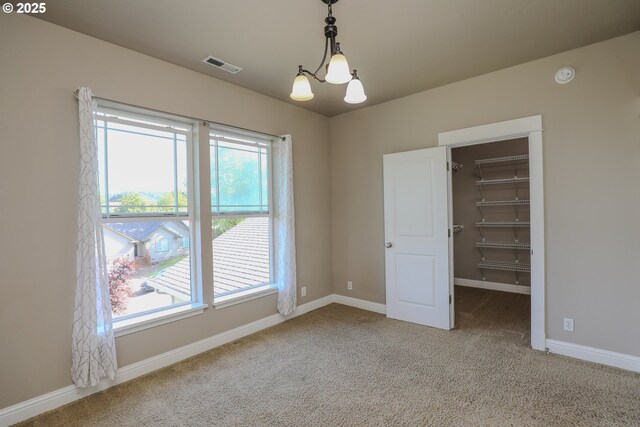 1680 NW Avery St, Roseburg, OR 97471 - spare room with a chandelier, carpet flooring, a smoke detector, and baseboards