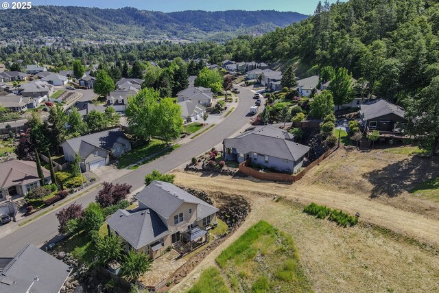 1680 NW Avery St, Roseburg, OR 97471 - aerial perspective of suburban area with a mountainous background and a heavily wooded area