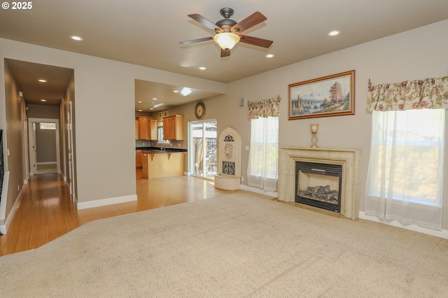 1680 NW Avery St, Roseburg, OR 97471 - living room featuring light wood-style floors, a ceiling fan, recessed lighting, baseboards, and a tiled fireplace
