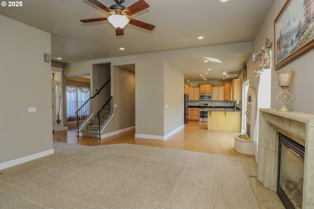 1680 NW Avery St, Roseburg, OR 97471 - unfurnished living room featuring recessed lighting, ceiling fan, a fireplace, baseboards, and stairway