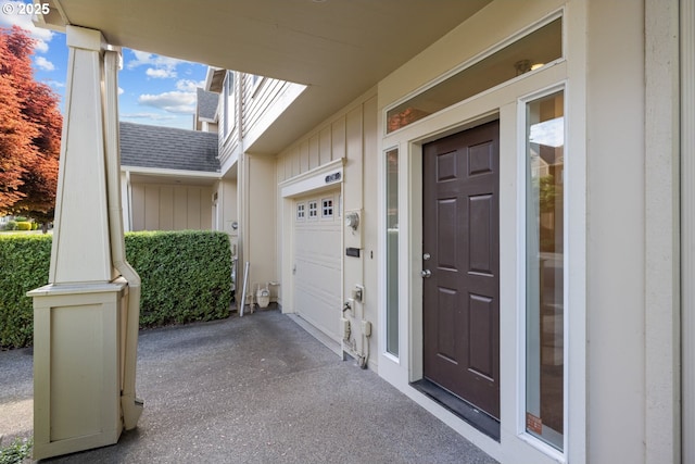 17246 SW Pleasanton Ln, Beaverton, OR 97003 - doorway to property featuring a shingled roof, a garage, board and batten siding, and driveway