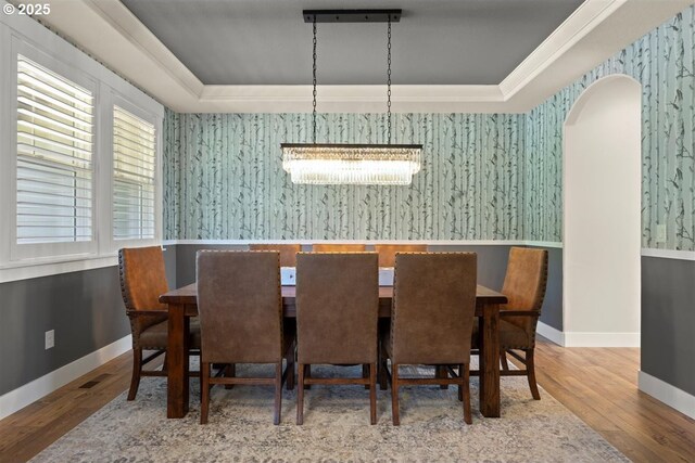 21823 NE 172nd St, Brush Prairie, WA 98606 - dining area with wood finished floors, wallpapered walls, a raised ceiling, arched walkways, and a notable chandelier