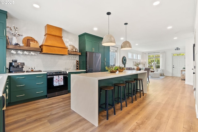kitchen featuring appliances with stainless steel finishes, open shelves, custom range hood, and light wood finished floors