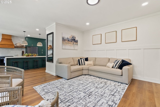 living area with light wood-style floors and recessed lighting