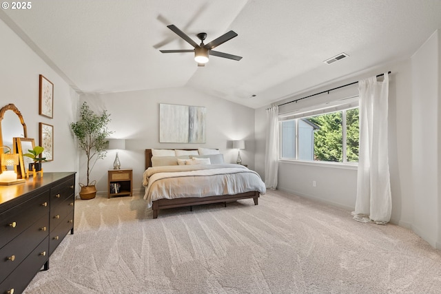bedroom with carpet floors, baseboards, vaulted ceiling, and visible vents