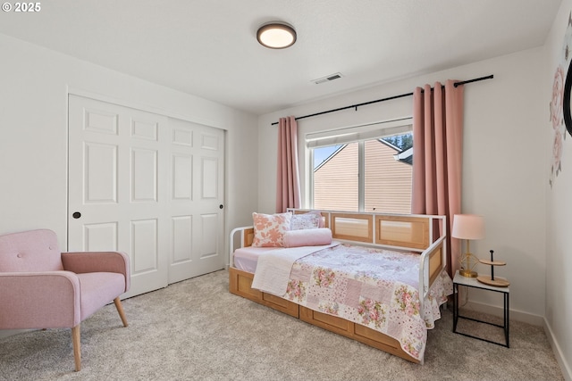 carpeted bedroom featuring a closet and visible vents