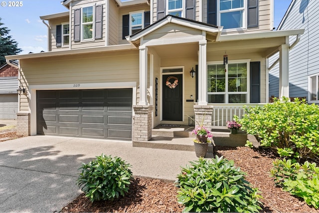 view of front of home with covered porch, an attached garage, and concrete driveway