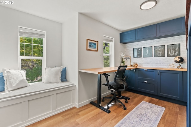 home office with a healthy amount of sunlight and light wood finished floors