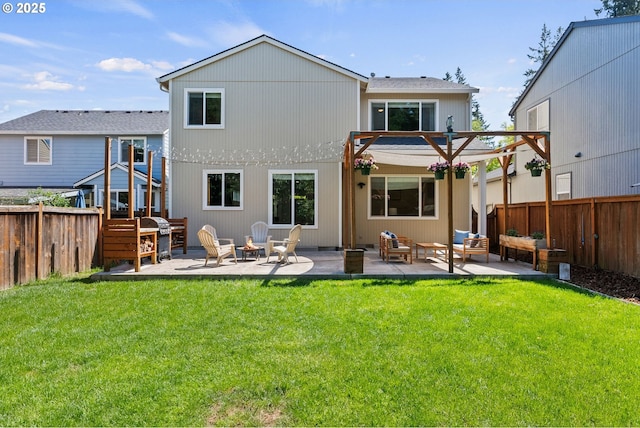 rear view of property with a fenced backyard, a yard, an outdoor living space, and a patio area