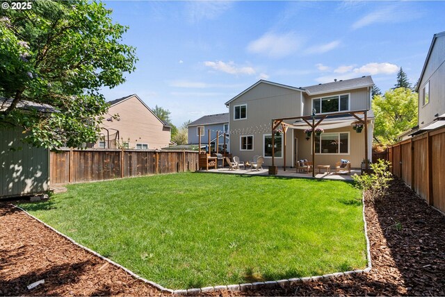 back of house featuring a lawn, a fenced backyard, and a patio area