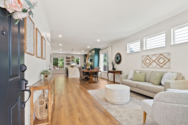 living area featuring recessed lighting, a wealth of natural light, and light wood-type flooring
